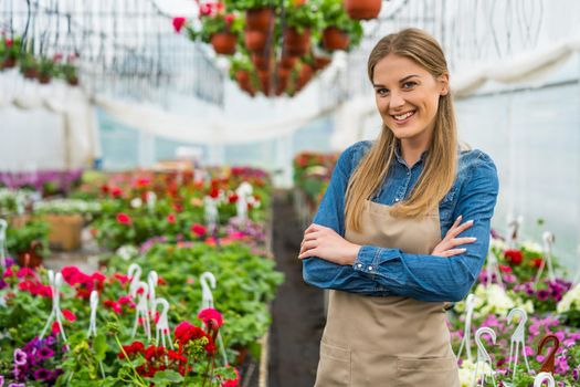 Woman is owning small business greenhouse store. Female entrepreneur.