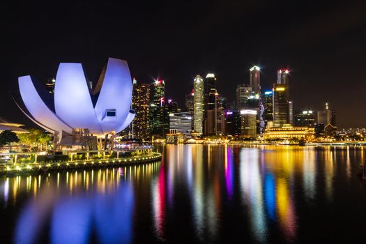 Singapore skyline cityscape with light around marina bay at night .