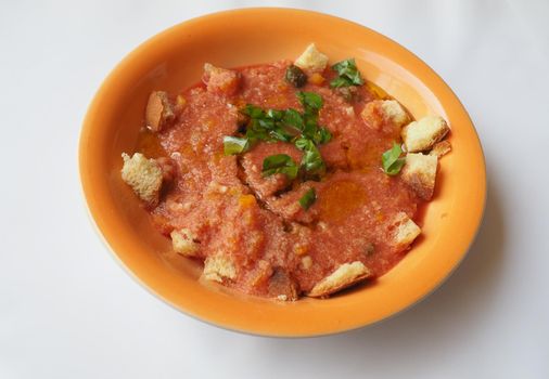 Dish of Spanish gazpacho cold soup made of tomato soup and bread