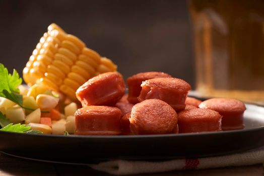 Grilled sausages with sauce ketchup on a wooden table