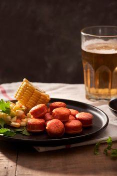 Beer and appetizing beer snacks set. Table with mug beer grilled sausages with sauces.
