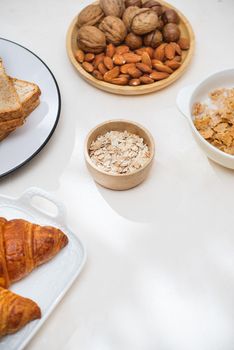 Health and colorful breakfast - waffles, muffins, almond, hazelnuts, various fresh fruits on table. Health food concept .Top view.