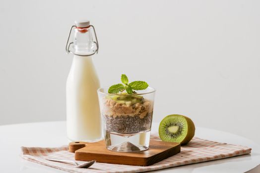 Healthy breakfast with yogurt, nut, kiwi and chia seeds. Bowl of fresh fruit.