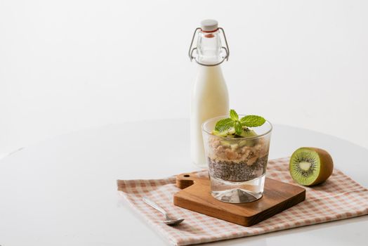 Healthy breakfast with yogurt, nut, kiwi and chia seeds. Bowl of fresh fruit.