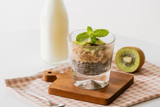 Healthy breakfast with yogurt, nut, kiwi and chia seeds. Bowl of fresh fruit.