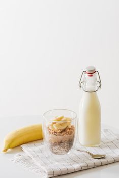 Healthy breakfast with yogurt, nut, banana and chia seeds. Bowl of fresh fruit.