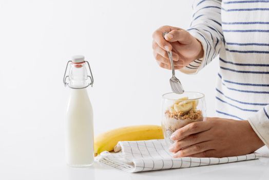 Healthy breakfast with yogurt, nut, banana and chia seeds. Bowl of fresh fruit.