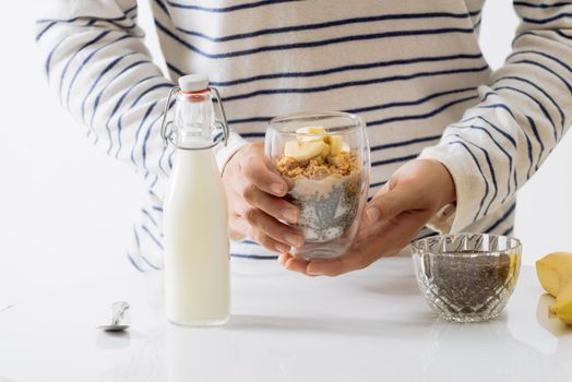 Healthy breakfast with yogurt, nut, banana and chia seeds. Bowl of fresh fruit.