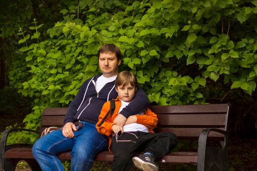 Dad with his son. The father hugged the child carefully. Child care, paternity, custody. A father's love.  