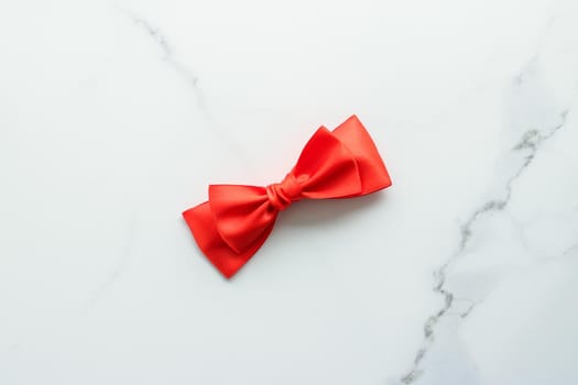 Holiday decor, feminine design and flatlay concept - Red silk ribbon on marble, top view