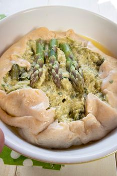 Vegan savory pie made with spelled flour and asparagus cream 