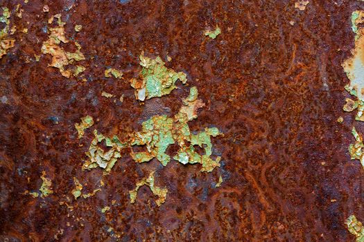 artisticly rusted flat iron surface with leftowers of peeled off paint.