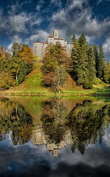 Medieval castle and lake reflection of Trakoscan, Croatia. Castle is settled on north west part of Croatia.