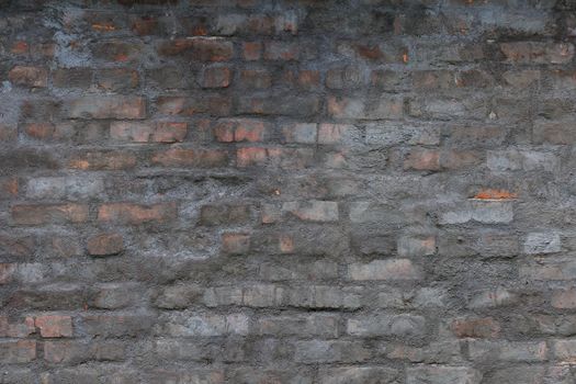 old brick wall with shabby gray cement plaster layer - background and texture
