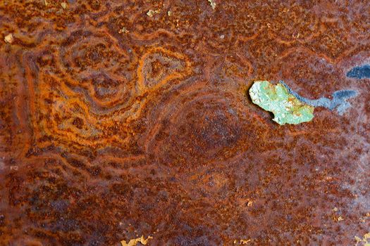 artisticly rusted flat iron surface with leftowers of peeled off paint.
