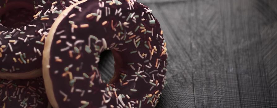 Bakery, branding and cafe concept - Frosted sprinkled donuts, sweet pastry dessert on rustic wooden background, doughnuts as tasty snack, top view food brand flat lay for blog, menu or cookbook design