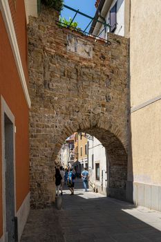 Muggia, Italy. June 13, 2021 the old city gate at the entrance to the historic center of the town