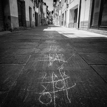 Muggia, Italy. June 13, 2021. the tic-tac-toe game drawn with chalk on the pavement of a narrow street in the town center
