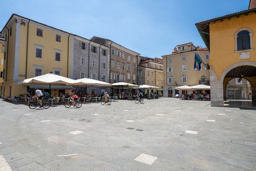 Muggia, Italy. June 13, 2021 People sitting at outdoor tables in the bars of Guglielmo Marconi Square in the town center