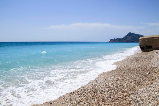 Cap Negret beach and Civil War bunker on a sunny day of Spring in Altea, Alicante, Spain.