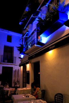 Altea, Alicante, Spain- June 12, 2021: People having drinks and enjoying nice weather in terraces at night in Altea village in Spain. 