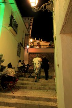 Altea, Alicante, Spain- June 12, 2021: People going shopping, walking and relaxing at night through the Narrow streets of Altea village, Alicante, Spain