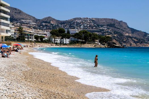 Altea, Alicante, Spain- June 12, 2021:Beautiful Cap Negret beach on a sunny day of Spring in Altea, Alicante, Spain