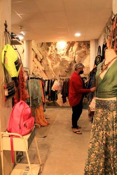 Altea, Alicante, Spain- June 12, 2021: People shopping at Handicraft and clothing store in Altea village, Spain