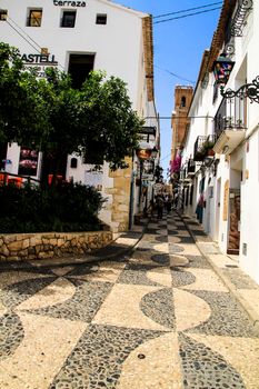 Altea, Alicante, Spain- June 12, 2021: Narrow streets and typical whitewashed facades in Altea village, Alicante, Spain