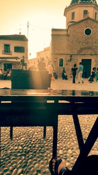 Altea, Alicante, Spain- June 12, 2021: People having drinks and enjoying nice weather in terraces in the main square of Altea village in Spain. 