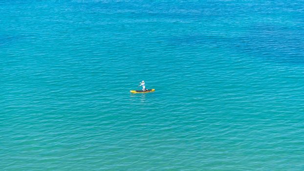 Seascape with a man on a sup board on the background of the water surface