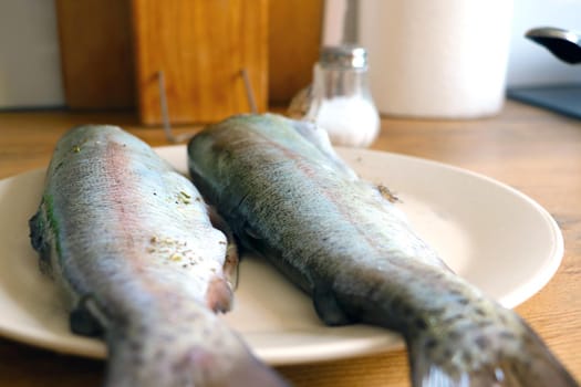 Two fish are in a plate. Cooking tasty and healthy fish for lunch