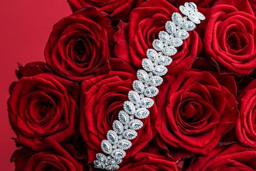 Gemstone jewellery, wedding fashion and luxe shopping concept - Luxury diamond bracelet and bouquet of red roses, jewelry love gift on Valentines Day and romantic holidays present