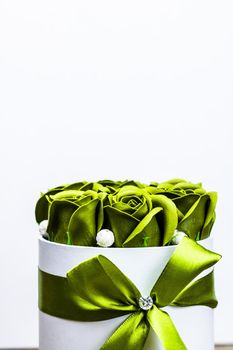 Green roses in a round luxury present box. Bouquet of flowers in a paper box isolated.