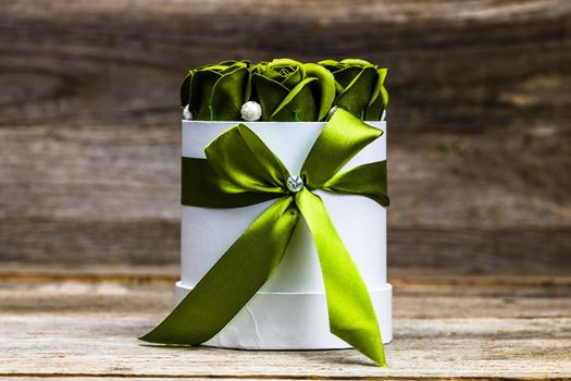 Green roses in a round luxury present box. Bouquet of flowers in a paper box isolated.