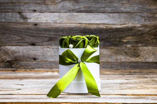 Green roses in a round luxury present box. Bouquet of flowers in a paper box isolated.