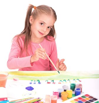 The child, a little girl draws paints