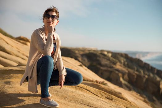 Woman seated looking to the beautitful view