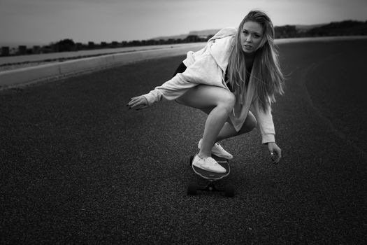 Girl making a downhill with her Skate