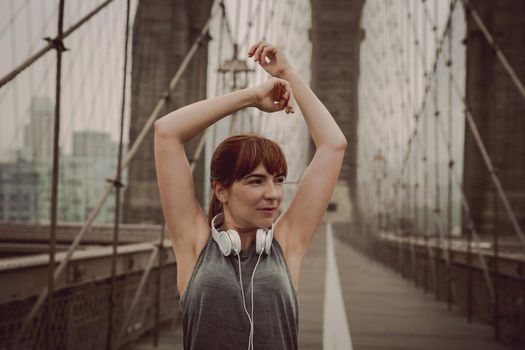 Woman on the Brooklyn bridge making a pause after the exercise