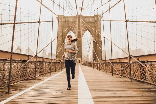 Woman practicing jogging on the Brooklyn bridge5