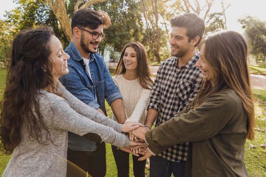 Group of friends joining their hands together