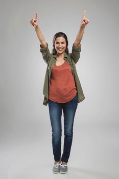 Beautiful and successful young woman with arms raised