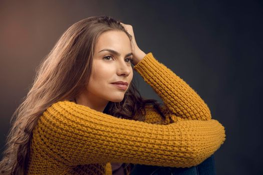 Shot of a beautiful young woman lost in thoughts