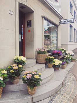 Wollerau, canton of Schwyz, Switzerland circa June 2021: Flower shop on street, Swiss architecture and real estate
