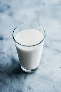 Dairy, healthy nutrition and breakfast concept - World Milk Day, full glass on marble table