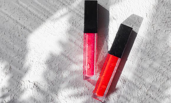 Lip gloss and sun shadow . The concept of lip gloss without labels. Decorative cosmetics. Lip care. Copy space