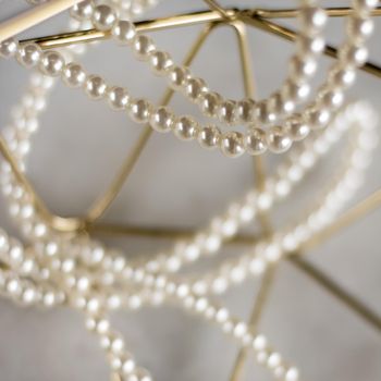 Pearl necklace on golden marble, ethical jewellery - luxury background, jewelry as a gift concept. Pearls are girl's best friends