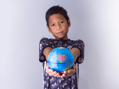 boy holding a globe stand out in front Show the power of the new generation to continue to develop our world.