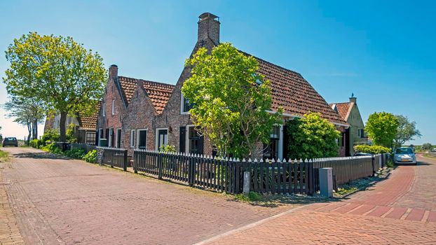 Old traditional dutch houses along the dyke in Moddergat Friesland the Netherlands
